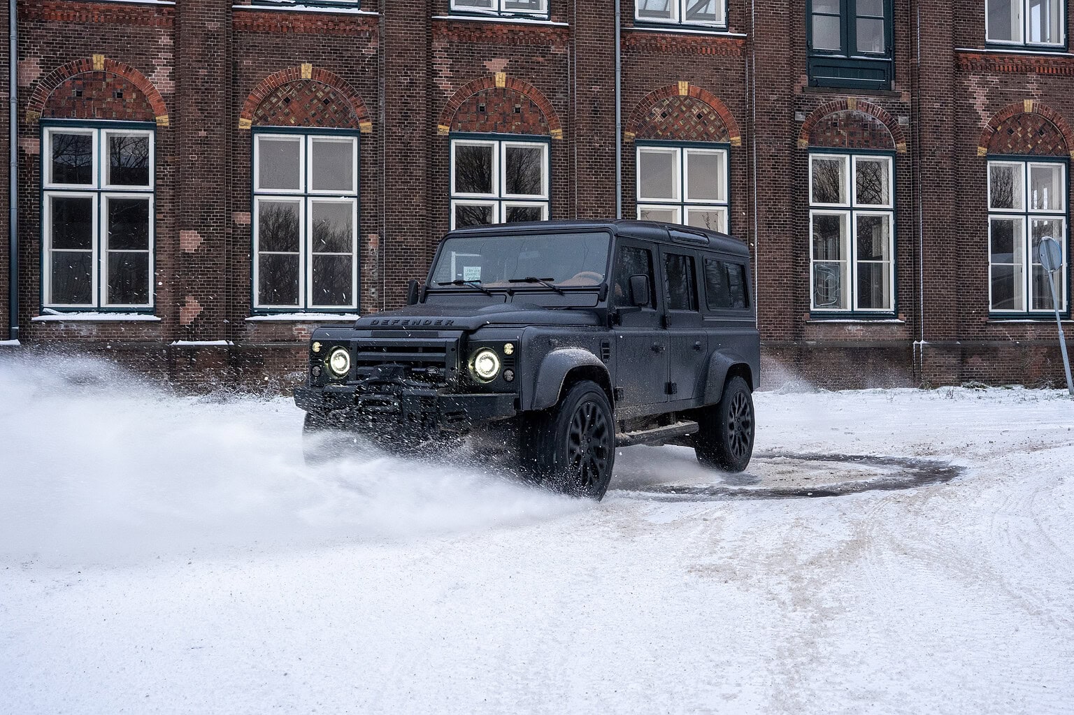 The Landrovers Alcide with Panther Turn in front of old building