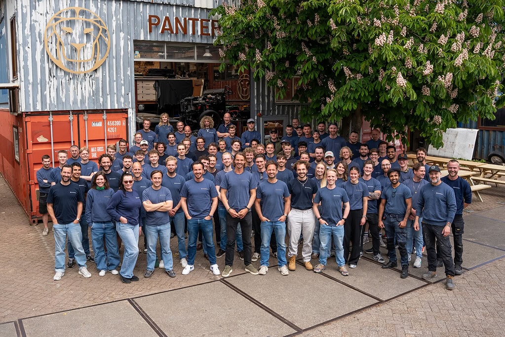 Team of owners and craftsmen and women of The Landrovers in Amsterdam in front of dream factory